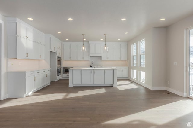 2989 Rock View Dr Unit 105, Francis, UT 84036 - kitchen with light wood-style flooring, white cabinetry, recessed lighting, appliances with stainless steel finishes, and light countertops