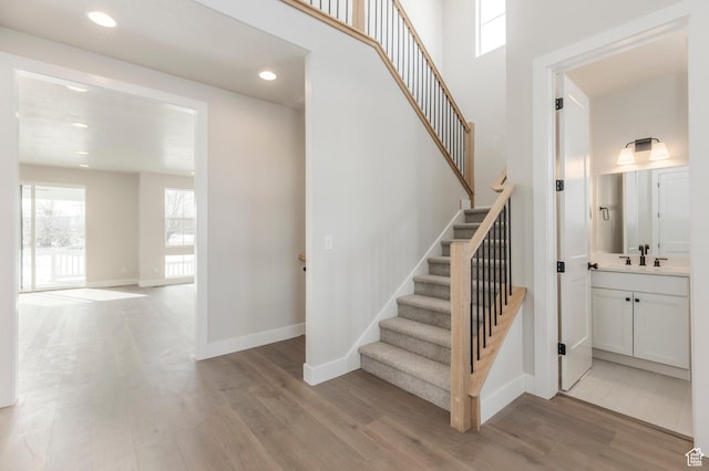 2989 Rock View Dr Unit 105, Francis, UT 84036 - stairway featuring a high ceiling, wood finished floors, baseboards, and recessed lighting