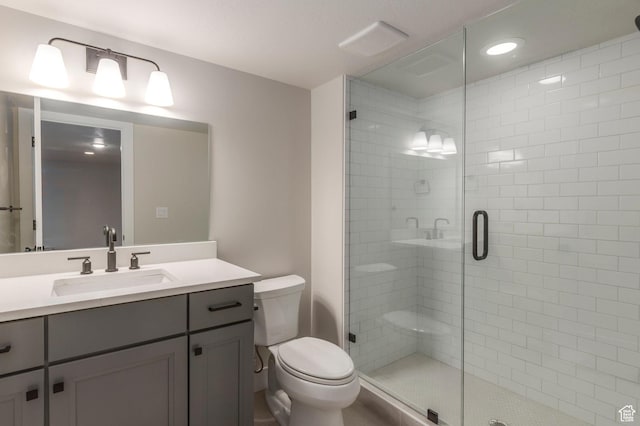2989 Rock View Dr Unit 105, Francis, UT 84036 - bathroom featuring toilet, vanity, a shower stall, and visible vents