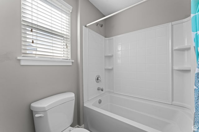 bathroom with toilet and shower / tub combo with curtain