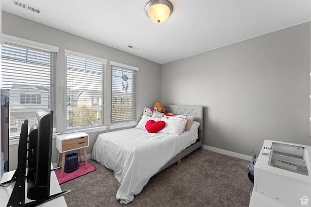 carpeted bedroom with visible vents and baseboards