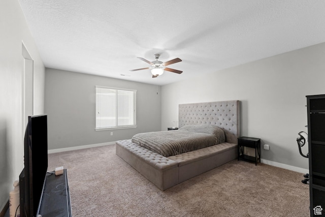 bedroom with a textured ceiling, baseboards, and carpet