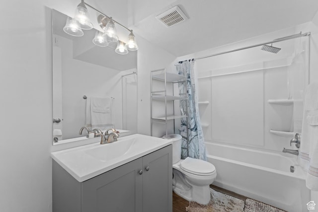 full bathroom with vanity, shower / bath combo, toilet, visible vents, and wood finished floors