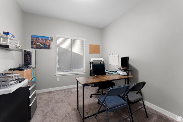 office area with baseboards, light colored carpet, and lofted ceiling