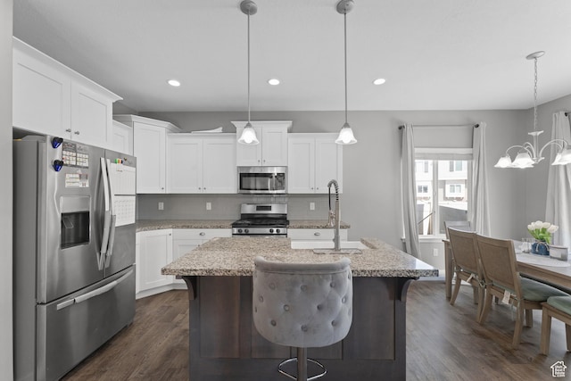 kitchen with stainless steel appliances, dark wood-style floors, a chandelier, and decorative backsplash