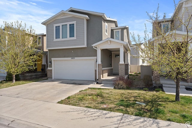 view of front of home with stucco siding, driveway, brick siding, a garage, and fence