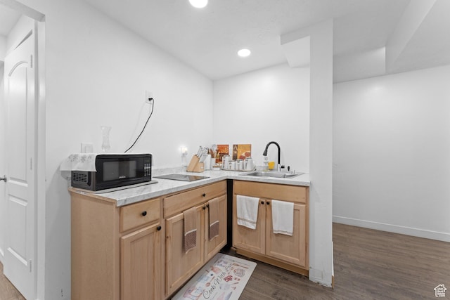 kitchen featuring a sink, dark wood-style flooring, light countertops, black appliances, and recessed lighting