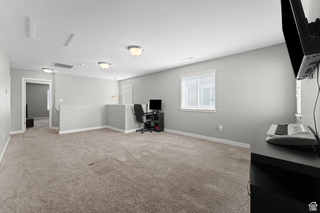 office featuring visible vents, baseboards, attic access, and light colored carpet