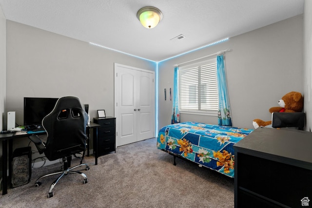bedroom featuring a closet, visible vents, and carpet floors