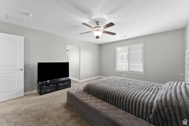 bedroom with visible vents, baseboards, ceiling fan, carpet, and a textured ceiling