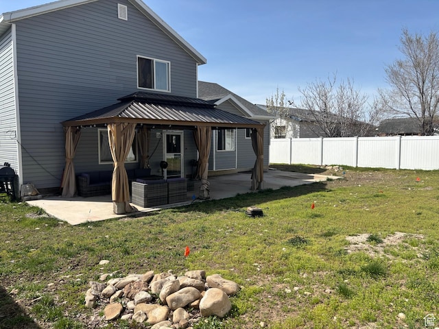 1081 S 900 W, Tooele, UT 84074 - back of house with a patio area, fence, and a lawn
