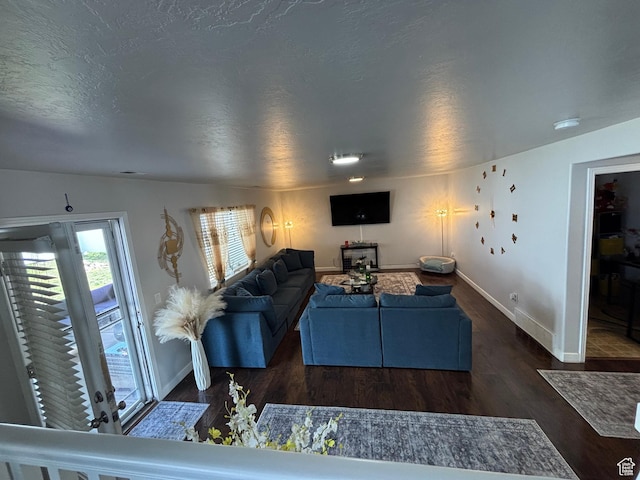 1081 S 900 W, Tooele, UT 84074 - living room featuring a textured ceiling, baseboards, and wood finished floors