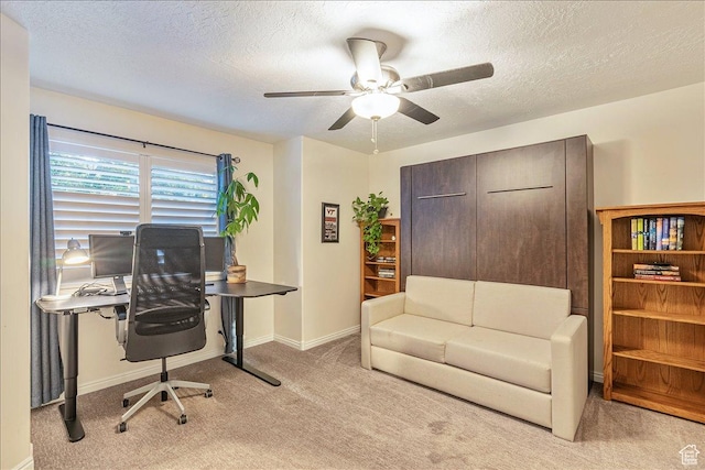 home office with carpet floors, baseboards, a ceiling fan, and a textured ceiling