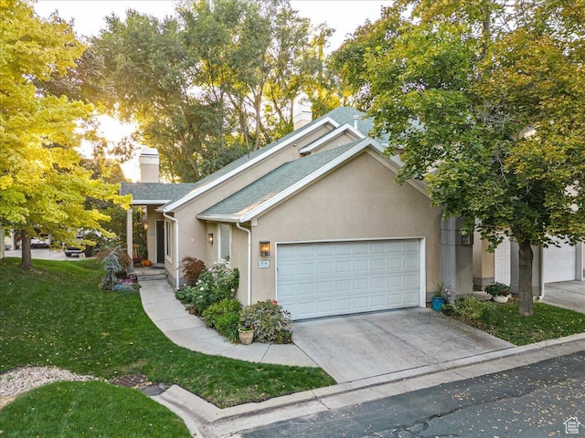 ranch-style house with concrete driveway, stucco siding, a garage, and a chimney