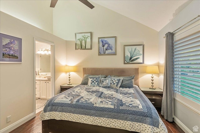 bedroom featuring dark wood finished floors, ensuite bathroom, baseboards, and lofted ceiling