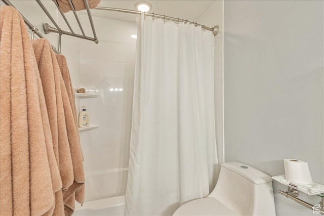 full bathroom with shower / bath combo with shower curtain and toilet
