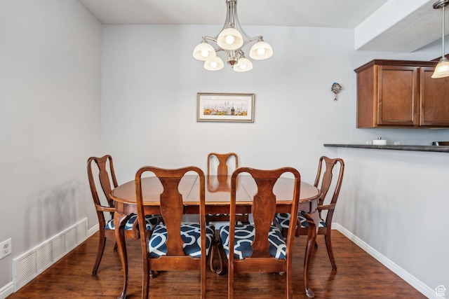 dining space featuring a chandelier, baseboards, dark wood-style floors, and visible vents