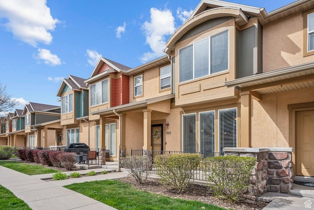 exterior space with stucco siding and a residential view