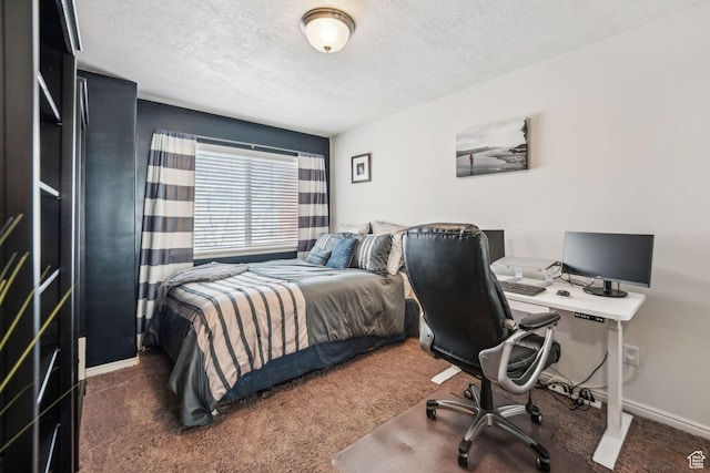 bedroom featuring a textured ceiling, baseboards, and carpet floors