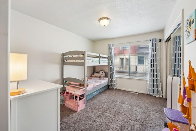 bedroom with baseboards and carpet