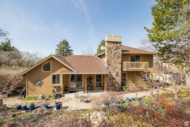 2406 Woodland Dr, Ogden, UT 84403 - back of house with stucco siding, a patio area, a balcony, a chimney, and a shingled roof