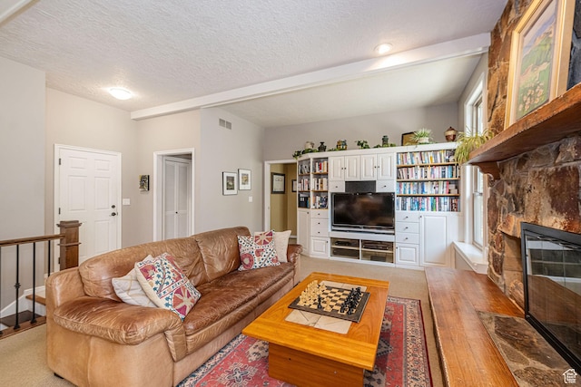 2406 Woodland Dr, Ogden, UT 84403 - living room featuring light wood-style flooring, a stone fireplace, a textured ceiling, and visible vents