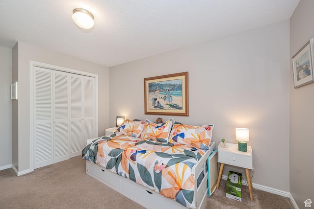2406 Woodland Dr, Ogden, UT 84403 - bedroom with carpet flooring, a closet, baseboards, and a textured ceiling
