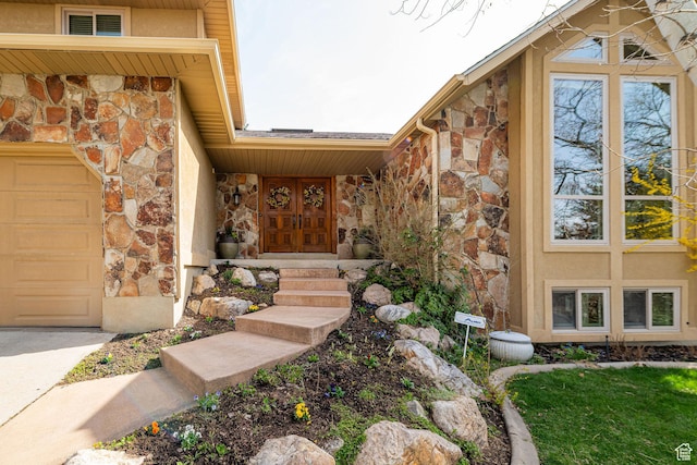 2406 Woodland Dr, Ogden, UT 84403 - doorway to property with a garage, stucco siding, and stone siding