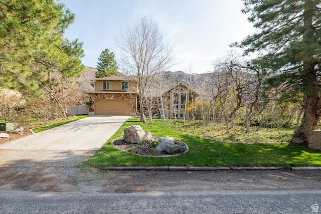 2406 Woodland Dr, Ogden, UT 84403 - view of front facade with stucco siding, stone siding, a front lawn, an attached garage, and driveway