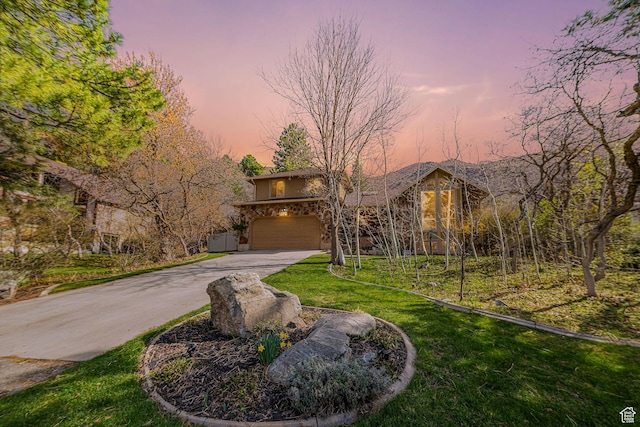 2406 Woodland Dr, Ogden, UT 84403 - view of front facade with driveway, stucco siding, a garage, and a lawn