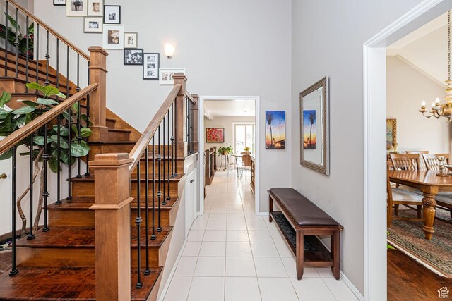 2406 Woodland Dr, Ogden, UT 84403 - foyer entrance with tile patterned floors, a notable chandelier, baseboards, and stairway