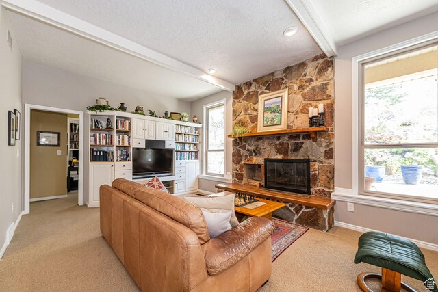 2406 Woodland Dr, Ogden, UT 84403 - living area with baseboards, a textured ceiling, a fireplace, beam ceiling, and light colored carpet