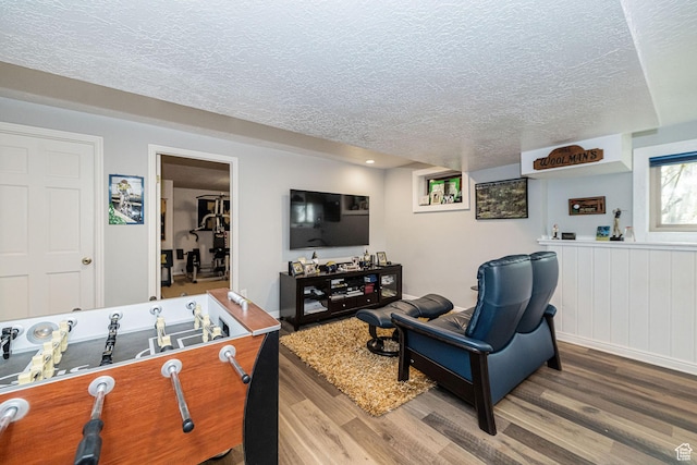 2406 Woodland Dr, Ogden, UT 84403 - recreation room featuring a textured ceiling and wood finished floors