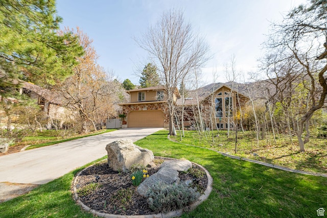 2406 Woodland Dr, Ogden, UT 84403 - view of front of home featuring a front yard, driveway, and an attached garage