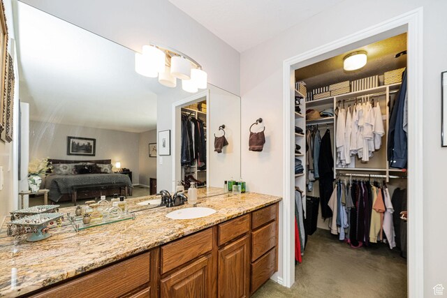 2406 Woodland Dr, Ogden, UT 84403 - bathroom with a walk in closet and vanity