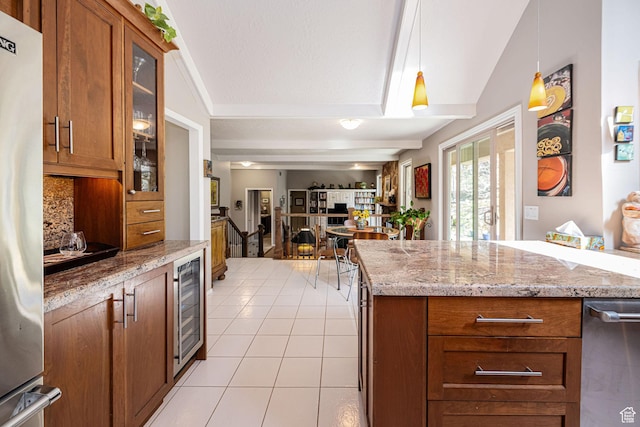 2406 Woodland Dr, Ogden, UT 84403 - kitchen with light tile patterned floors, vaulted ceiling, and brown cabinetry