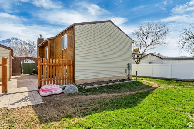 1224 S 760 W, Provo, UT 84601 - view of side of home with a yard, a patio area, fence, a chimney, and a mountain view