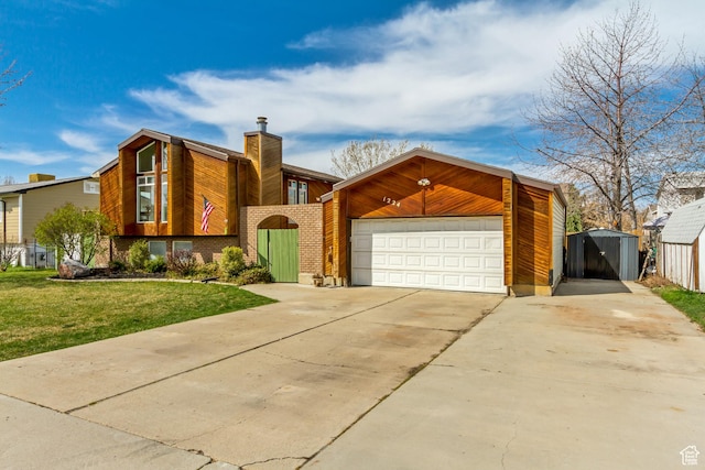 1224 S 760 W, Provo, UT 84601 - view of front of property with an outbuilding, a front lawn, brick siding, a chimney, and concrete driveway