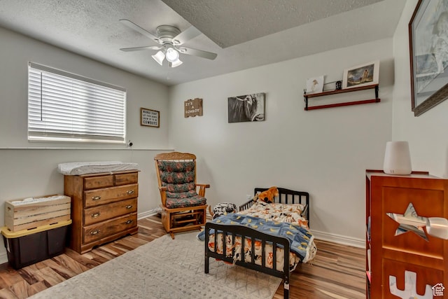 1224 S 760 W, Provo, UT 84601 - bedroom featuring a textured ceiling, wood finished floors, baseboards, and a ceiling fan