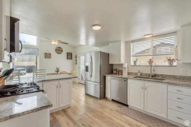 1224 S 760 W, Provo, UT 84601 - kitchen with a sink, backsplash, appliances with stainless steel finishes, and white cabinetry