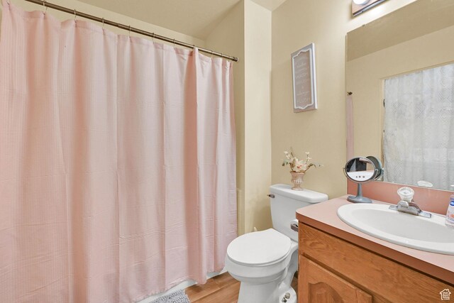 992 E 5625 S, South Ogden, UT 84405 - full bath featuring toilet, a shower with shower curtain, vanity, and wood finished floors