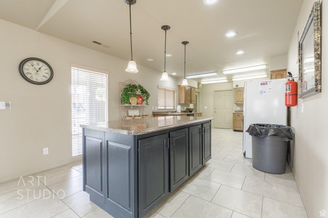145 S Crystal Lakes Dr Unit 80, St George, UT 84770 - kitchen with a center island, light tile patterned floors, freestanding refrigerator, recessed lighting, and decorative light fixtures