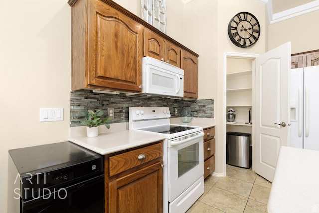 145 S Crystal Lakes Dr Unit 80, St George, UT 84770 - kitchen featuring white appliances, backsplash, light countertops, light tile patterned floors, and brown cabinetry