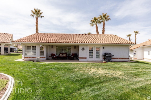 145 S Crystal Lakes Dr Unit 80, St George, UT 84770 - rear view of house with french doors, a yard, a tiled roof, and stucco siding