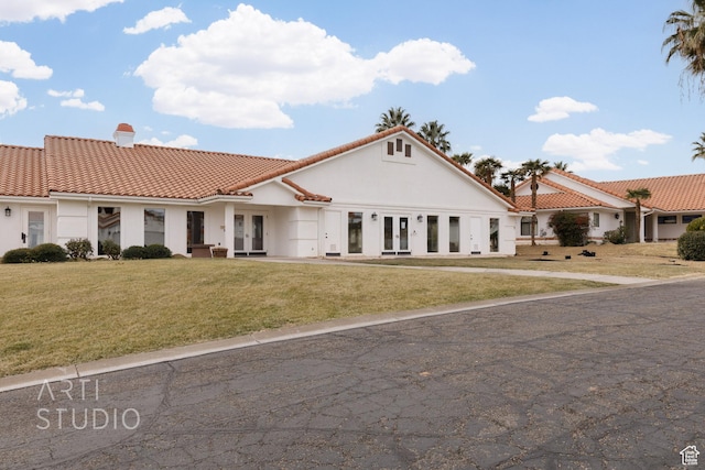 145 S Crystal Lakes Dr Unit 80, St George, UT 84770 - mediterranean / spanish-style house featuring french doors, stucco siding, a front yard, and a tiled roof