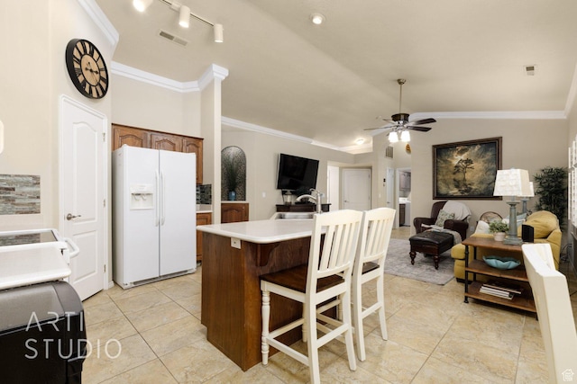 145 S Crystal Lakes Dr Unit 80, St George, UT 84770 - kitchen with white fridge with ice dispenser, ornamental molding, ceiling fan, open floor plan, and light countertops