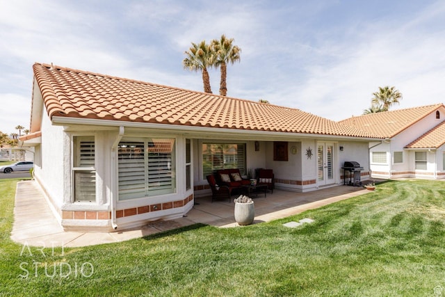 145 S Crystal Lakes Dr Unit 80, St George, UT 84770 - back of house featuring a lawn, a tile roof, a patio area, and stucco siding