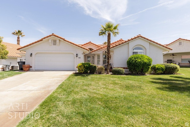 145 S Crystal Lakes Dr Unit 80, St George, UT 84770 - mediterranean / spanish home featuring a garage, concrete driveway, a tile roof, a front yard, and stucco siding