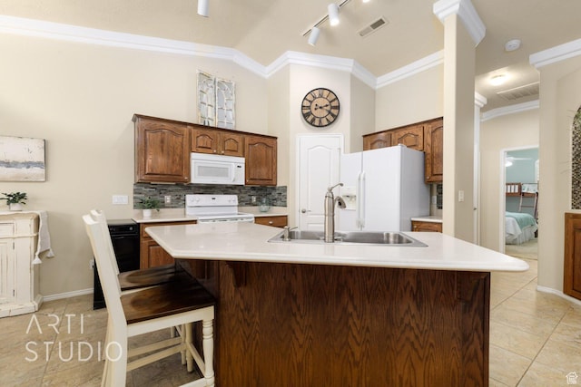 145 S Crystal Lakes Dr Unit 80, St George, UT 84770 - kitchen featuring white appliances, crown molding, light countertops, backsplash, and light tile patterned flooring