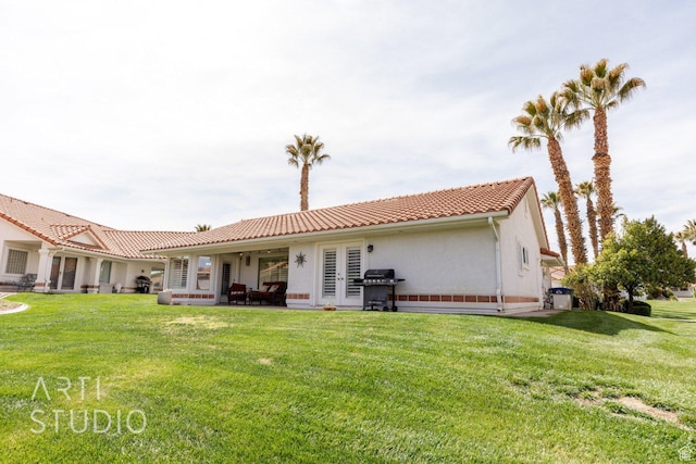 145 S Crystal Lakes Dr Unit 80, St George, UT 84770 - back of house featuring a yard, a tiled roof, and stucco siding